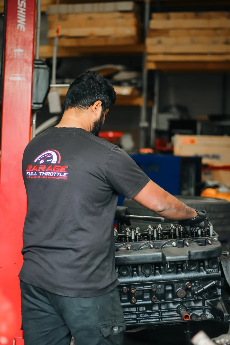 Mechanic Working on Engine and Drivetrain Service Garage Full Throttle