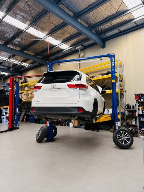 White Toyota Kluger raised on a hoist with wheels removed at Garage Full Throttle's Craigieburn workshop