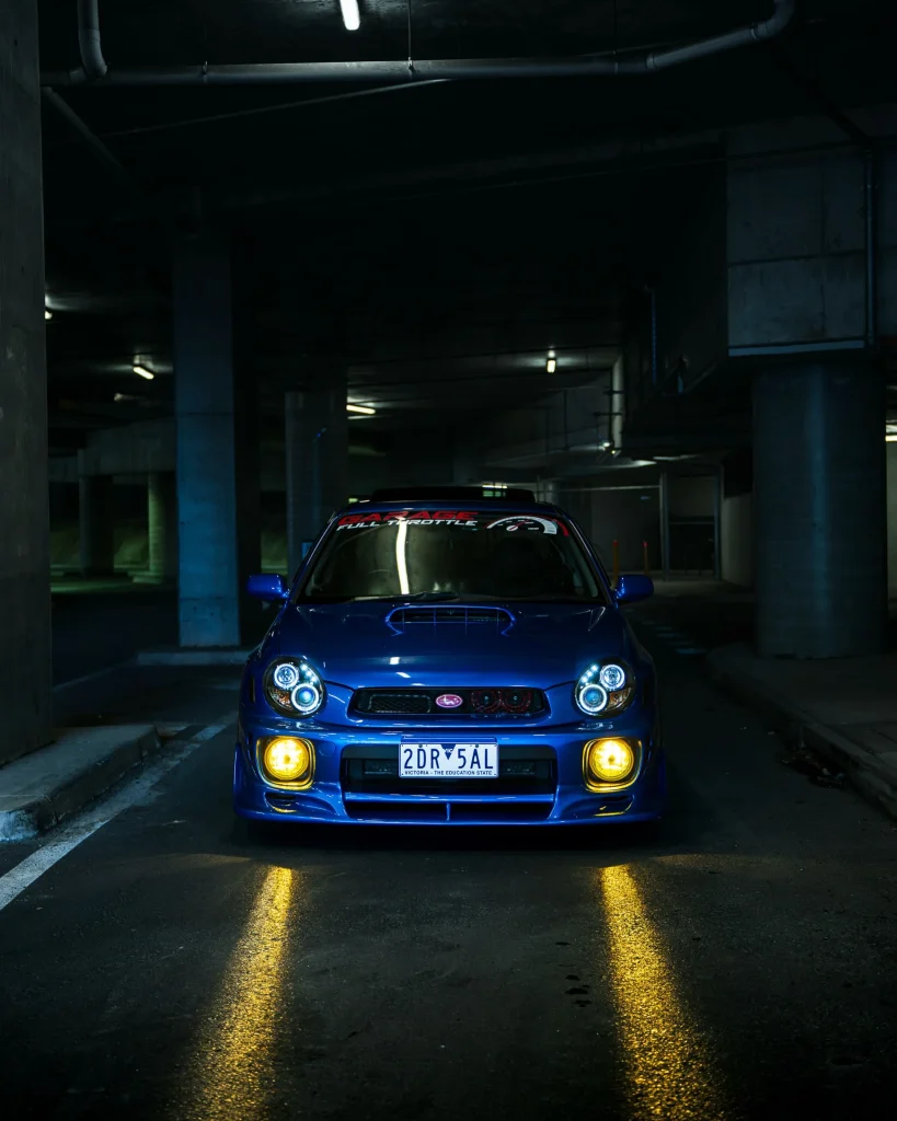 Silver Subaru Impreza inside the Garage Full Throttle workshop in Craigieburn, alongside vehicles raised on hoists